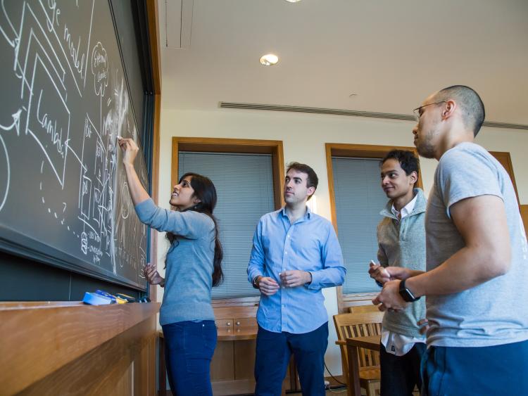 Students Writing on Chalkboard