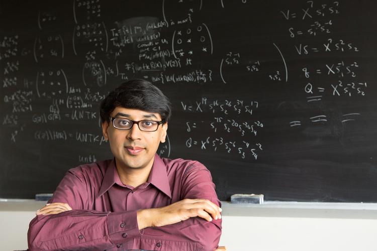 Faculty sitting near chalkboard
